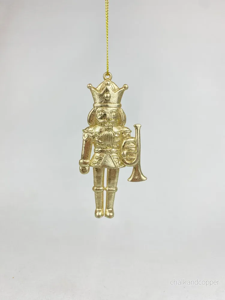 Hänge nötknäppare guld trumpet